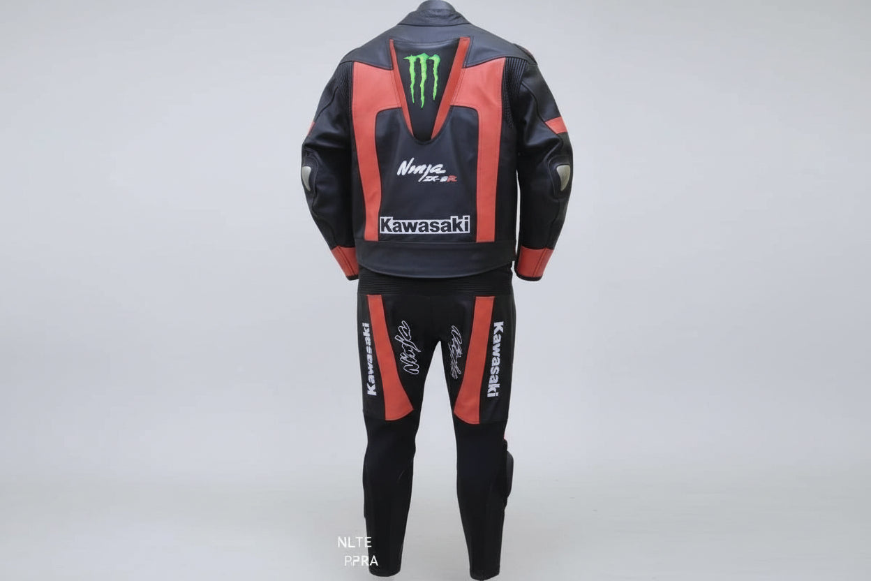 Detailed view of the Monster Energy claw logo, Kawasaki branding, and red technical leather panels on a professional two-piece suit.