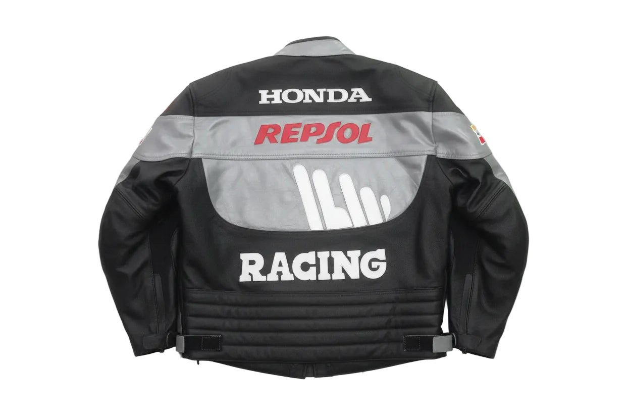 Detailed view of the red Repsol chest logo, white Racing graphics, and slate grey leather panels on a professional Honda jacket.