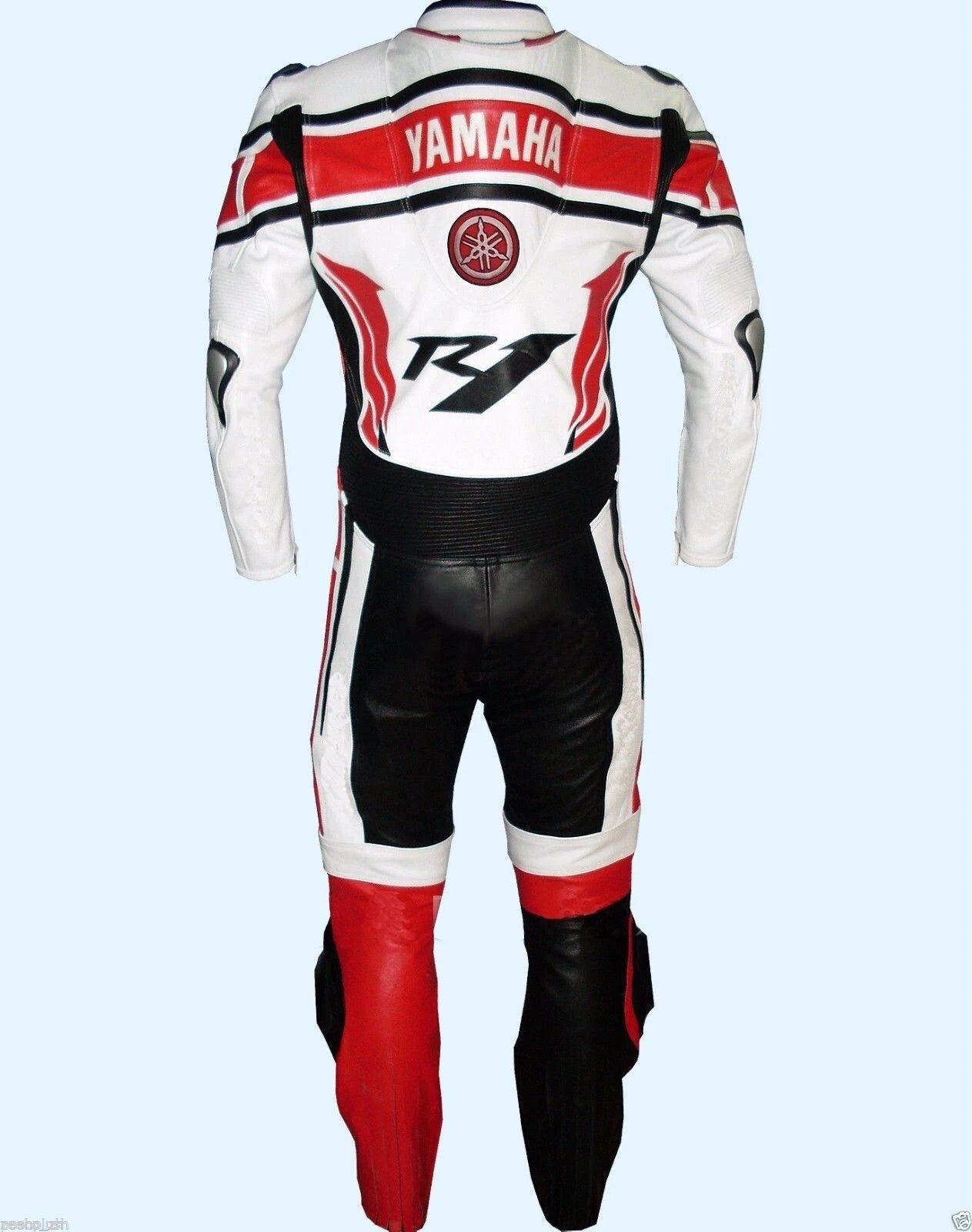 Detailed view of the Yamaha chest branding, R1 model graphics, and white accordion stretch panels on a professional racing suit.