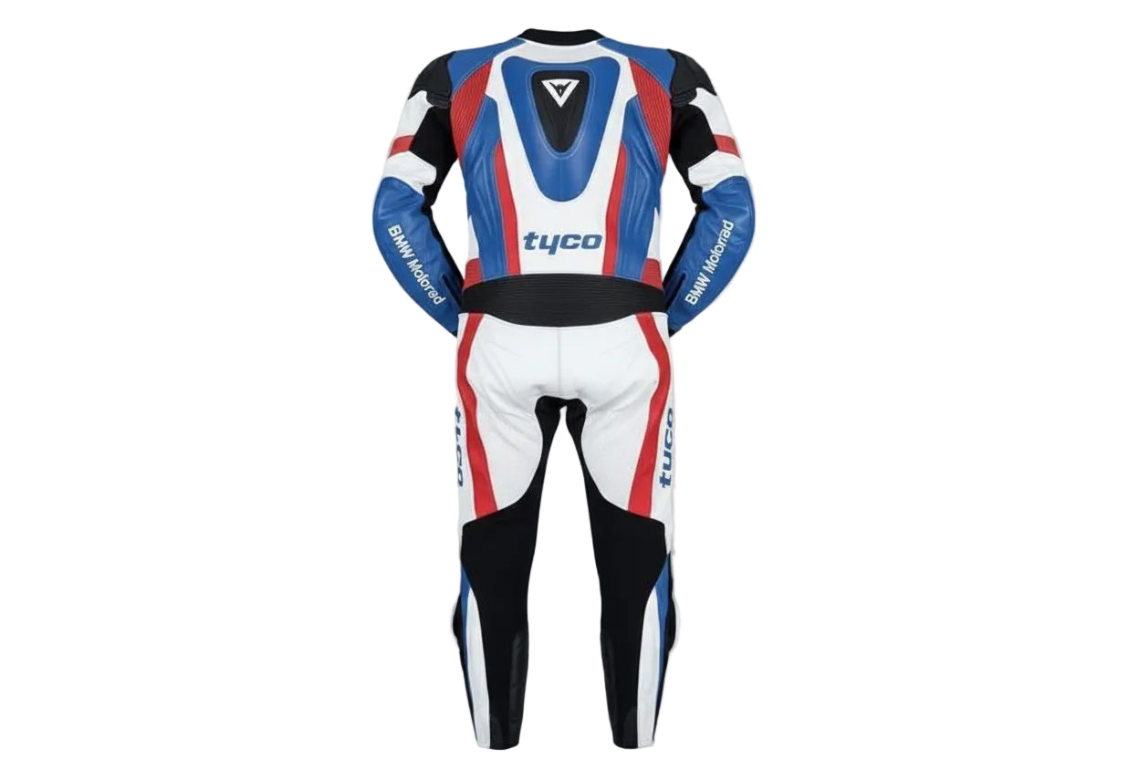 Detailed view of the BMW M roundel, Tyco sponsor patch, and perforated leather panels on a professional racing suit.