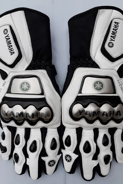 Yamaha leather motorcycle racing gloves in white and black with metallic knuckle armor.