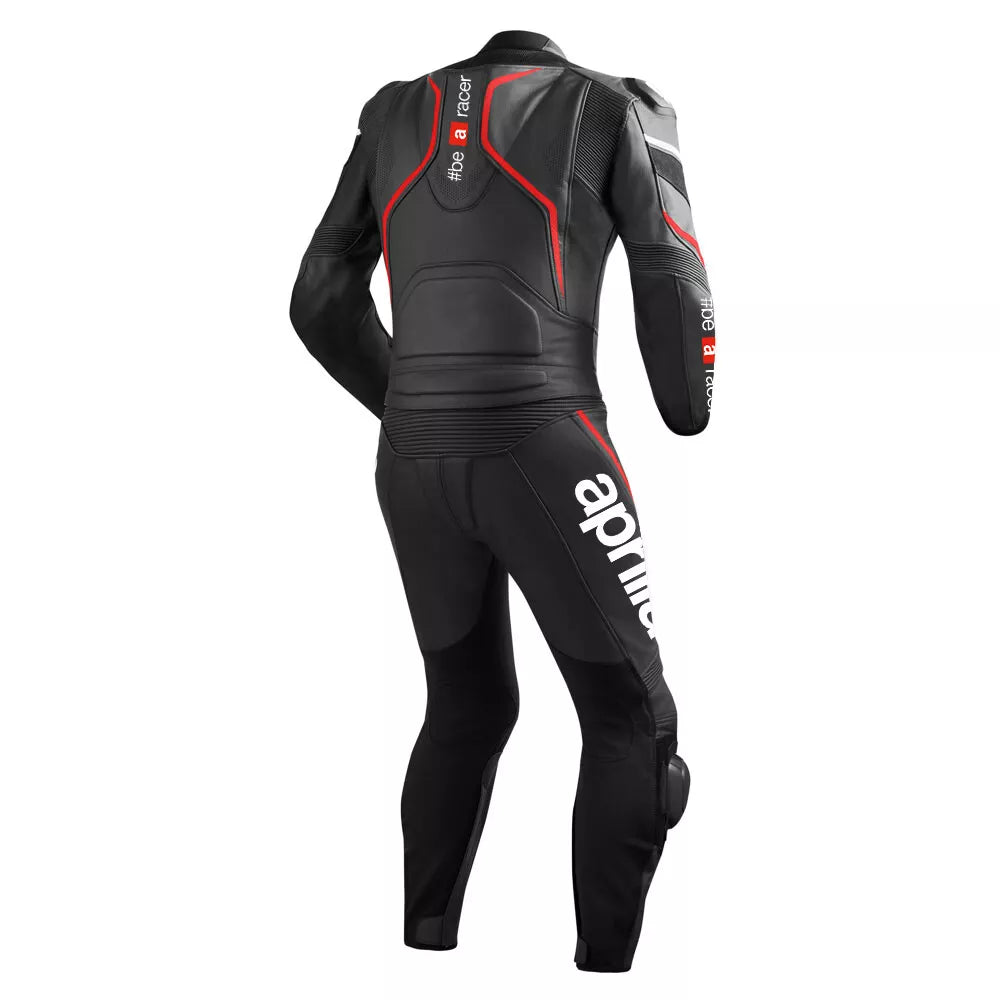 Detailed view of the red accordion stretch panels, Aprilia Racing chest logo, and SBK sponsor patch on a professional racing suit.